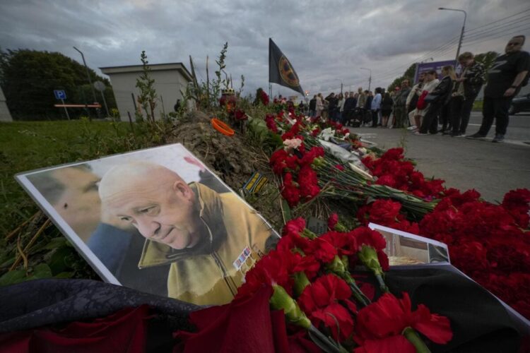 Image of a mural to Wagner Group commander Evgeny Prigozhin established outside of the former Wagner Center in St Petersburg. The image shows a picture of Evgeny Prigozhin with mourners in the background.