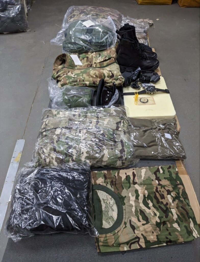 An image showing military clothing issued to new Wagner Group recruits at the Molkino training center in Krasnodar. The clothing consists of camouflage uniforms, boots, and protective gear.